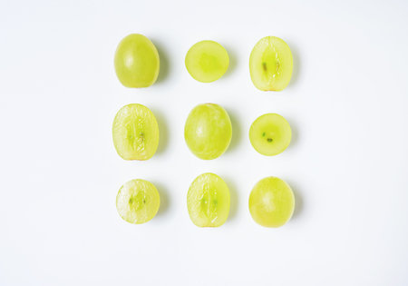 Creative flat lay made of  green grapes  on white background. Top view and copy space. Food concept.