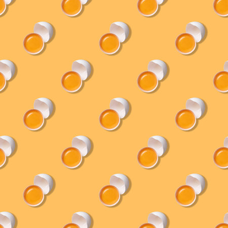 Creative seamless pattern with a chicken broken egg on a yellow background. Easter concept. Top view