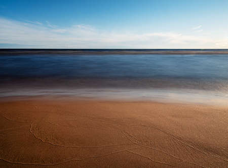 Beautiful lanscape on the sandy beach Ladoga lake with blue sky and surface  at sunny day. Ladoga lake,  Karelia. Mock up and copy space  imageの写真素材