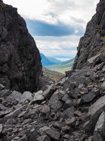 A beautiful landscape of the gorge with the peaks of the Khibiny mountains and a lake on a sunny day. Kola Peninsula, Russiaの写真素材