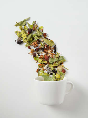 Cup of herbal  tea with fruits on a white background. The concept of a healthy drink. Top view and copy space.の写真素材
