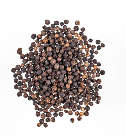 Aroma  spice black  pepper is scattered on a white isolated background. Top view.