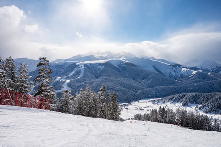 Beautiful landscape of the Arkhyz ski resort with mountains, snow, forest and track on a sunny winter day. Caucasus  Mountains, Russia.の写真素材