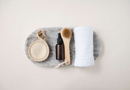 Flat lay of facial and body care cosmetics with creme, brush, sponge and towel  on marble board on light  background. Zero waste concept. Top view and copy space.の写真素材