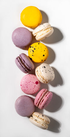 French sweet macaroons on a white background with a shadow. Concept delicious food. Top viewの写真素材