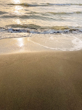Black Sea waves and sandy beach with water during sunset or sunrise. Concept of advertising banner...