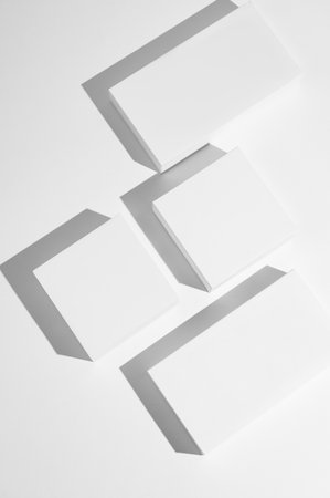 Minimalist blank rectangular and square boxes casting shadows on white background, representing clean packaging or branding concept. Top view, copy space.の写真素材