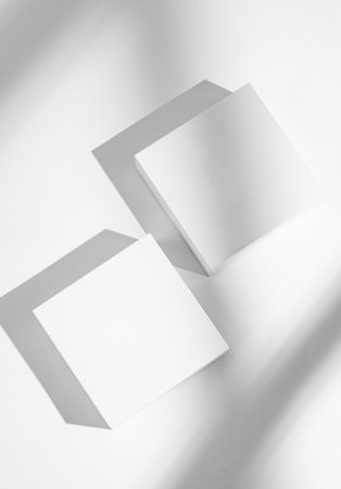 Two empty cubes, boxes or podium on a white background with soft shadows. Concept abstract geometric design for advertising or product demonstration. Top view, copy space.の写真素材