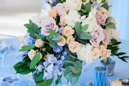 Closeup of a bouquet of flowers rose and delphinium and candlesの写真素材
