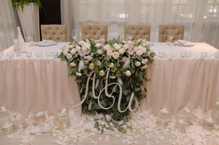 Wedding table decorated with bouquet and candlesの写真素材