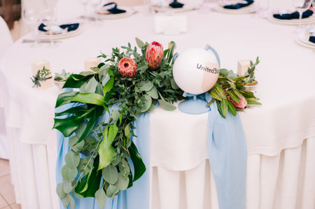 Wedding guest table decorated with bouquet and settings