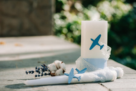 Tender boutonniere with candles decorated with cloth and small airplane