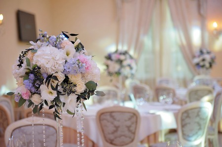 Wedding guest table decorated with bouquet and settingsの写真素材