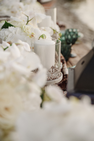 Candlestick on wedding table, between orchidsの写真素材
