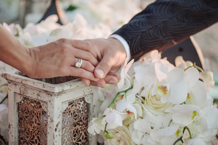 Newlyweds staying arm in arm on vintage backgroundの写真素材