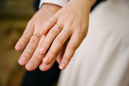 Newlyweds staying arm in arm, with wedding ringsの写真素材