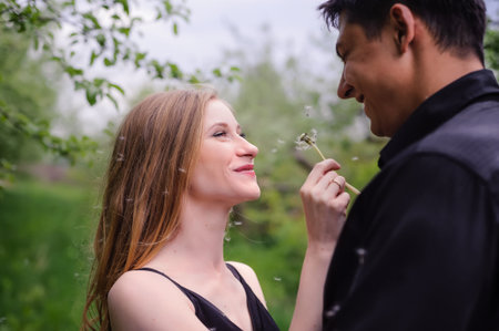 Wonderful love story in photos. Pretty pair in green fruit garden.の写真素材