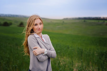 Wonderful love story in photos. Portrait of girl against fieldの写真素材