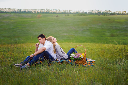 Wonderful love story in photos. Pretty pair on green fieldの写真素材