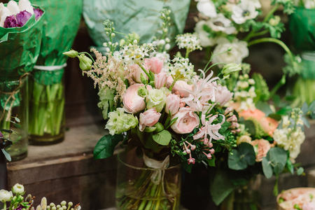 Bouquet of roses. petals and other flovers in vaseの写真素材