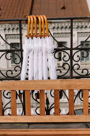 Closed white umbrellas as decoration for the wedding ceremonyの写真素材