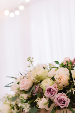 Floral bouquet with the white and lilac roses and greeneryの写真素材
