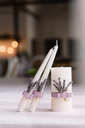 Beautiful candles for wedding tradition. The wedding candles decorated with a tape and krushevyの写真素材