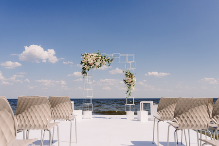 Wedding ceremony on the seashore. A modern wedding and an arch in industrial styleの写真素材