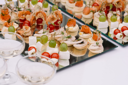 Colourful snack on a holiday table. The range of food for an entertainment of guests at a weddingの写真素材