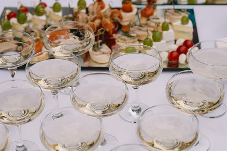 Glasses with champagne on a holiday table. The buffet table on a celebrationの写真素材