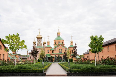 The big Christian temple with domes and the green yardの写真素材