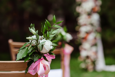 Small bouquet sideways backs of a wooden chair.の写真素材