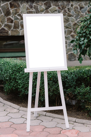 The plan of seating of guests at a wedding. A detail of a wedding decor on an easelの写真素材