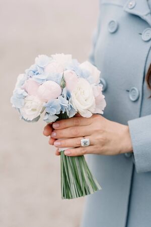 Bouquet of buds of pioneer, blue hortension in the hands of a girl.の写真素材
