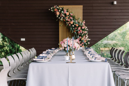 Carsy wedding table for guests in the restaurant decorated with flowers and stylish service. Art...