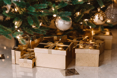 Christmas decorations with christmas tree and gifts in gold boxes