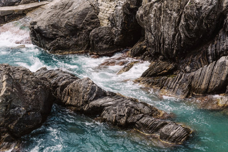 Huge grey rocks on the coast of the Mediterranean Sea in Italy
