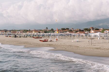 Forte del marmi, large beach in Italy. Boats on the coast of the Mediterranean Sea. Empty sandy beachの写真素材