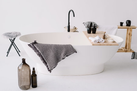 Stylish bathroom and beautiful oval bath. White walls and modern bathroom. Spa and relax concept