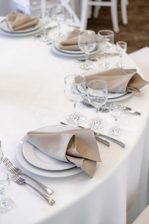 Luxurious wedding table decoration for reception of guests with stylish napkins, cute natural flower