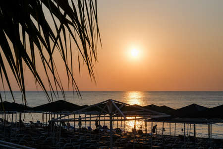Beautiful sunset sunrise beach with pink sky and pier. Travel, relax and meditation conceptの写真素材