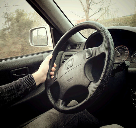 Hand of a man on a steering wheel