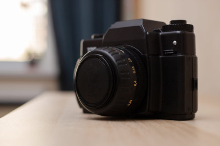 retro camera in black, which is located on a light table top
