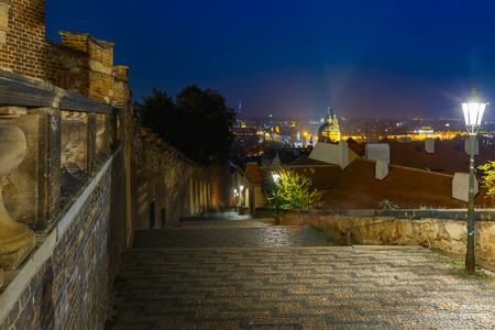 Cobbled street with stairs of the old town at night in Mala Strana, Prague, Czech Republicの写真素材