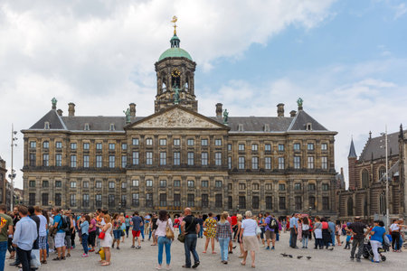 Amsterdam, The Netherlands - July 29, 2014: Tourists in front of the Royal Palace on Dam Square. The town square Dam - the center of commercial and political life of the city.のeditorial素材
