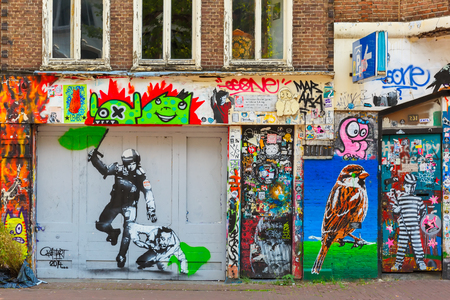 Amsterdam, Netherlands - August 1, 2014: Urban graffiti on a dilapidated house on the street Spuiのeditorial素材
