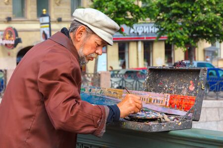 St. Petersburg, Russia - June 10, 2013: Street artist paints river landscape on the bridge over the Neva River.のeditorial素材