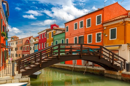 Bridge and canal with colorful houses on the famous island Burano, Venice, Italyの写真素材