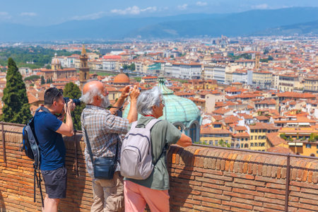 Florence, Tuscany, Italy - May 17, 2015: Tourists photographing scenic view of the city of Florence from Fort Belvedere at sunny day.のeditorial素材
