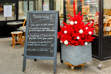 Paris, France - December 22, 2015: Restaurant menus and Christmas tree on the street in Parisのeditorial素材